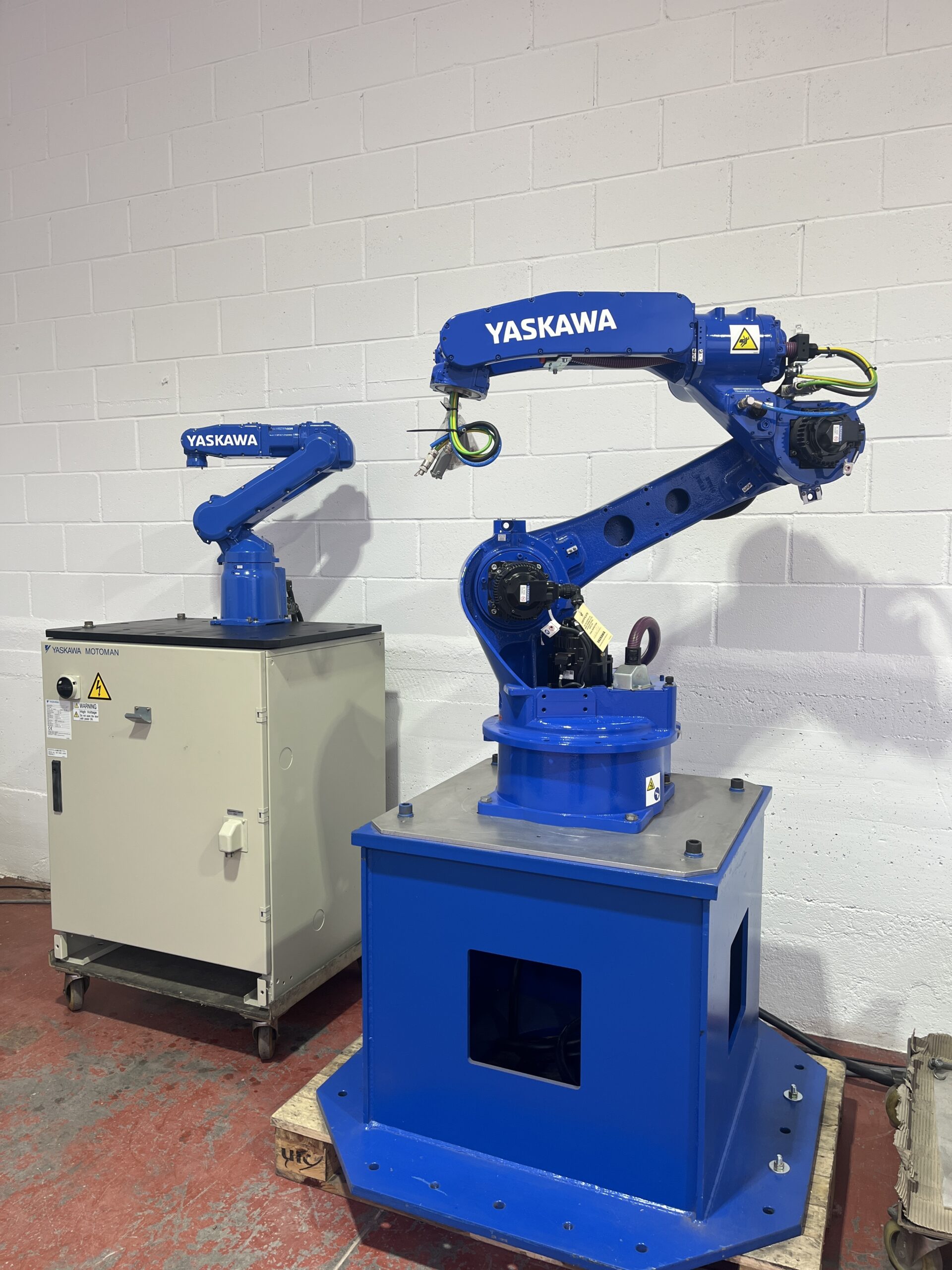 Ejemplo de robot Industrial Yaskawa Pequeño al lado de un brazo robótico yaskawa grande.