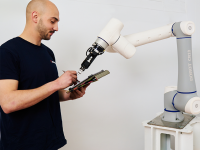 Técnico de empresa de robots colaborativos haciendo el mantenimiento de un cobot de pinza de la marca dobot